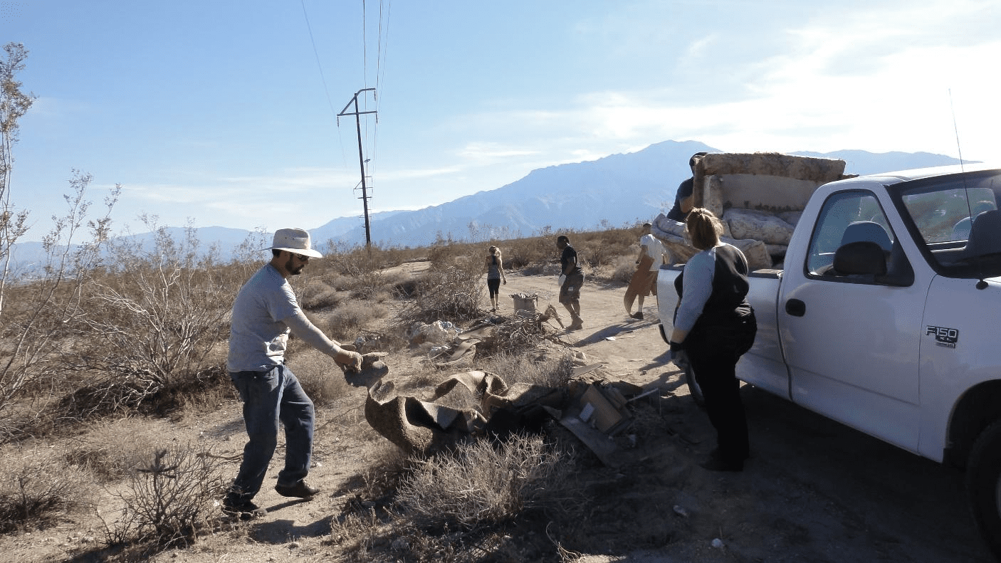 Volunteers removing debris from landscape